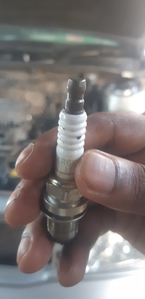 replace spark plug to solve clicking noise when accelerating
