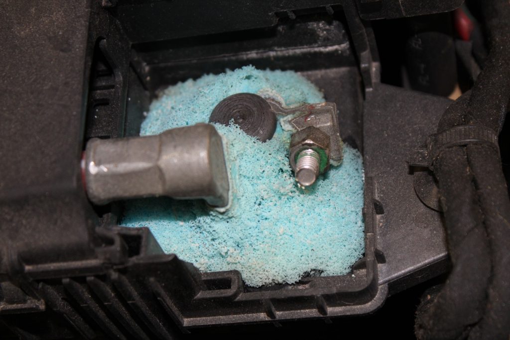 Corroded battery terminals are caused by a chemical reaction with the hydrogen gas released by the battery acid and the metal terminals.